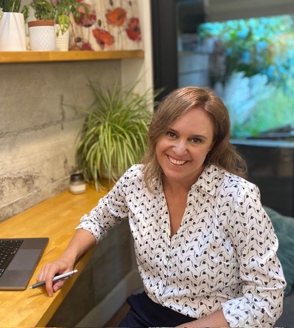 Georgina DeCarlo at her desk